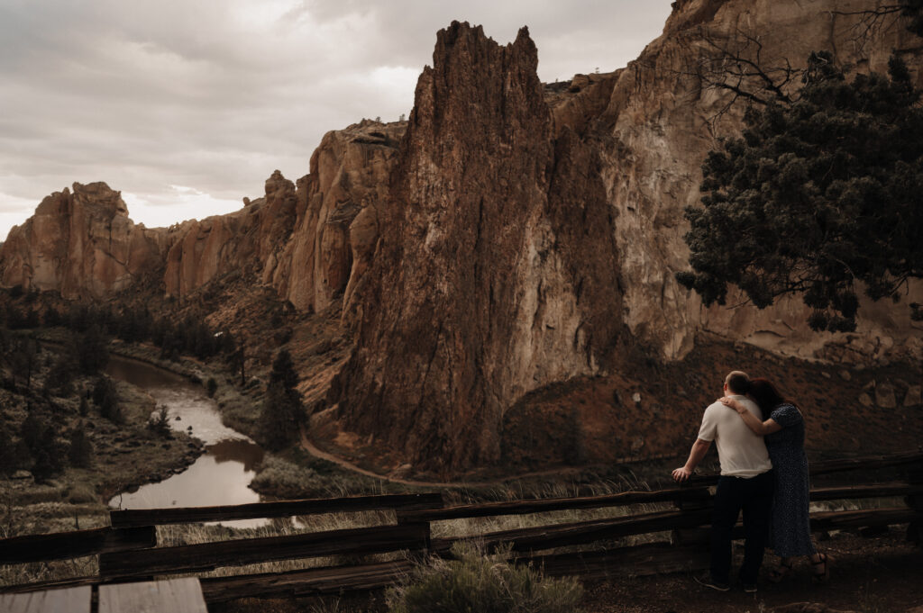 Couple overlooking Crooked River at Smith Rock State Park during engagement photos