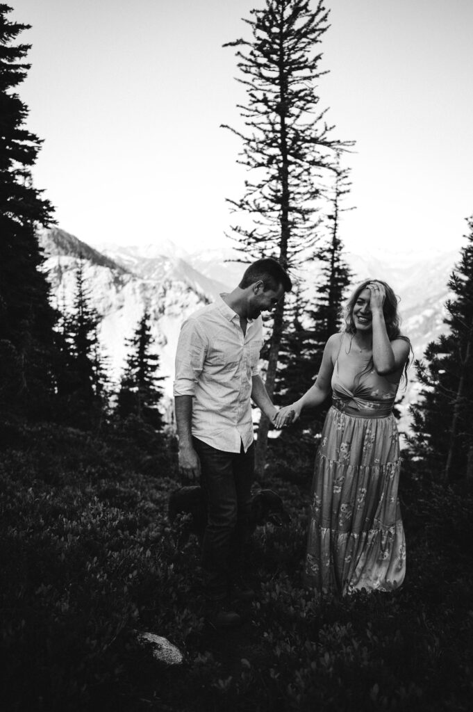 black and white photo of couple laughing during engagement session in North Cascades National Park