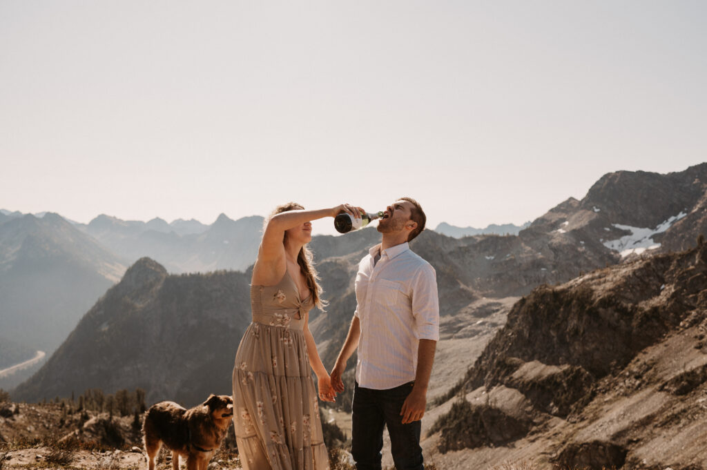 couple drinks champagne after surprise proposal in North Cascades National Park