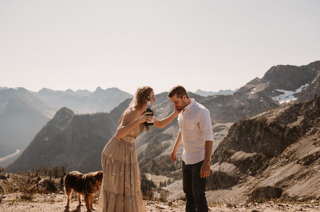 couple drinks champagne after surprise proposal in North Cascades National Park