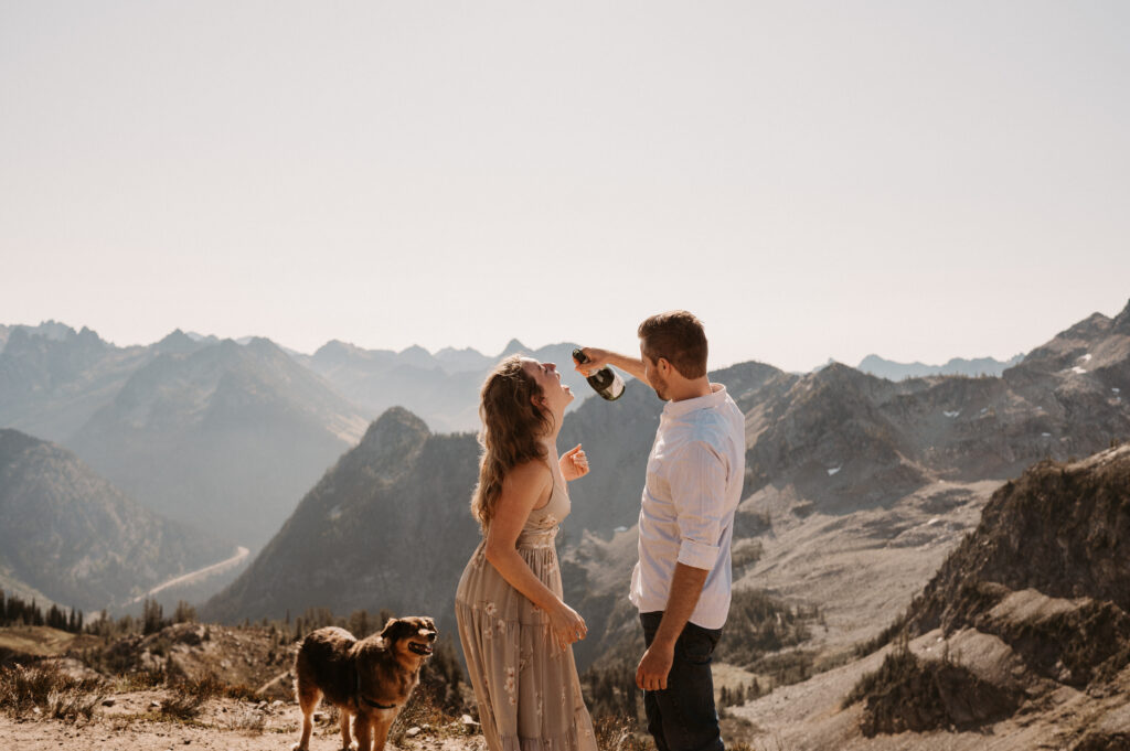 couple drinks champagne after surprise proposal in North Cascades National Park