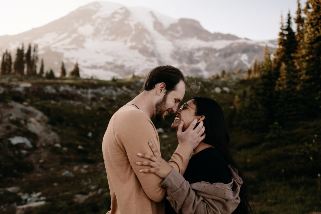 couple embracing in front of mount rainier during engagement photos