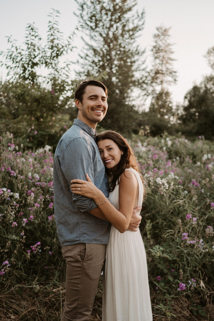 couple embracing in front of wildflowers in Washington State