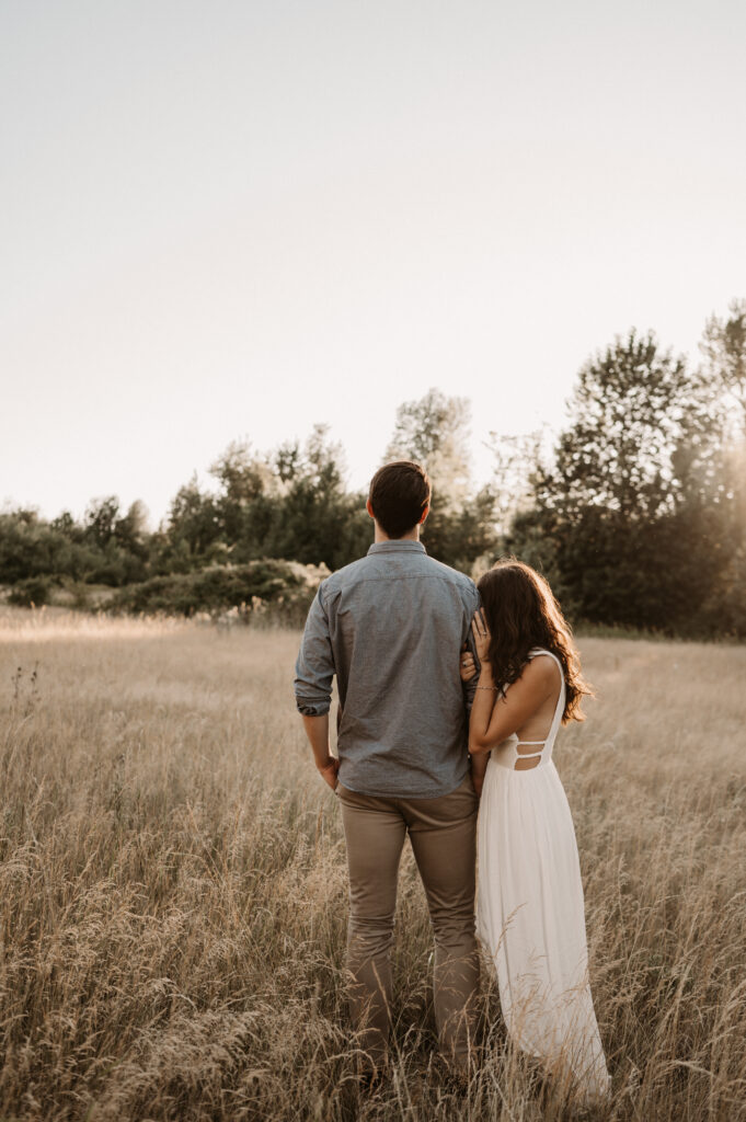 couple stands in field for columbia river gorge engagement session