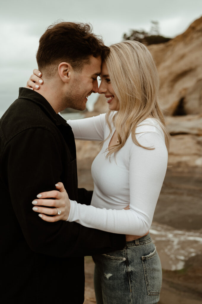 couple embracing during an Oregon coast engagement session