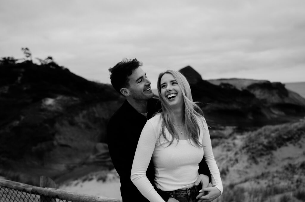 couple laughing at oregon coast engagement session