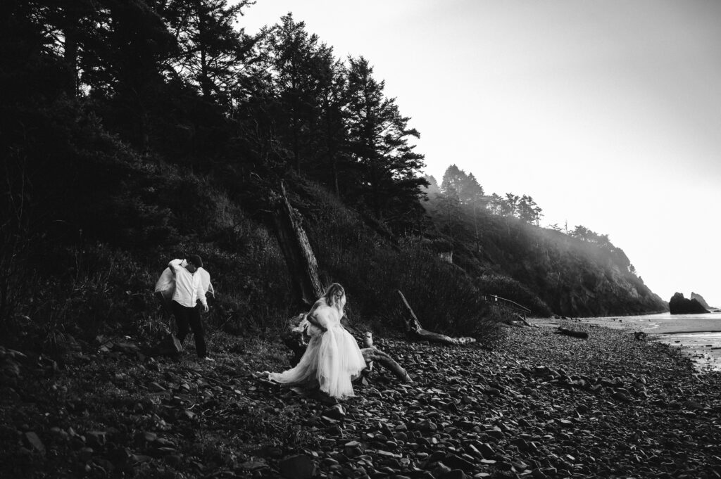 bride walking on beach during oregon coast elopement