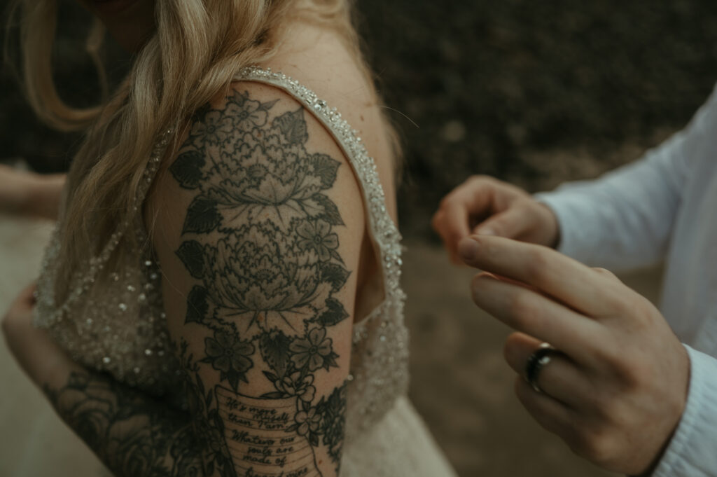 detail of brides arm and wedding dress
