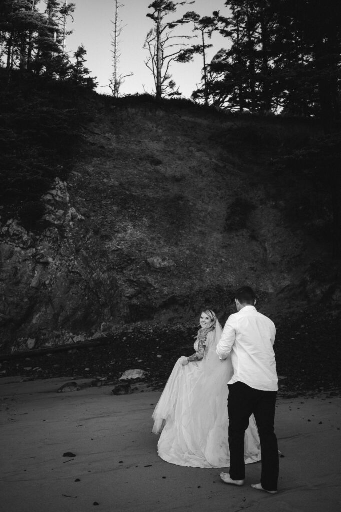 bride looking back at groom during oregon coast elopement