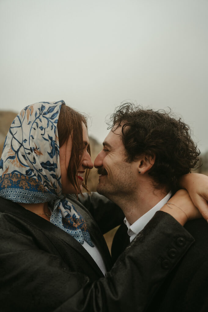 couple tickles noses during oregon coast couples session