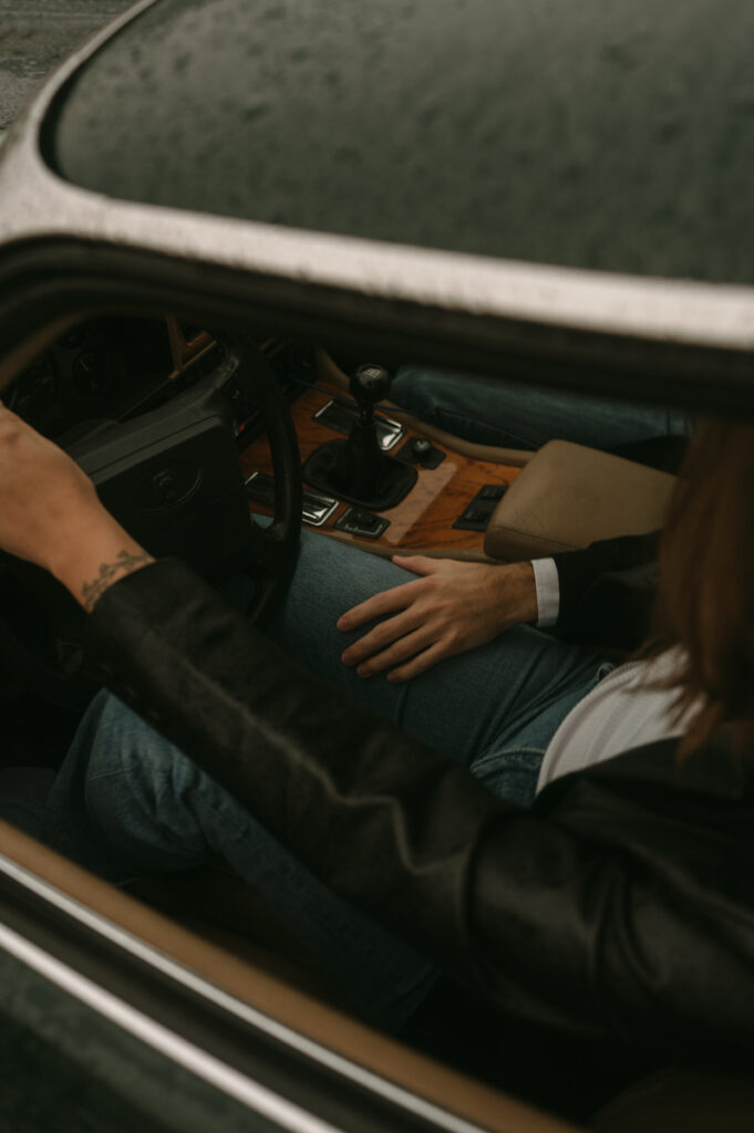 hand on leg in classic jaguar during oregon coast couples session