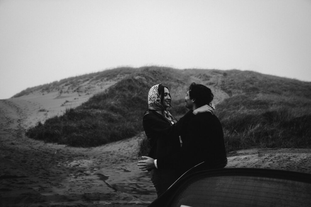 black and white of couple looking at each other during oregon coast couples session