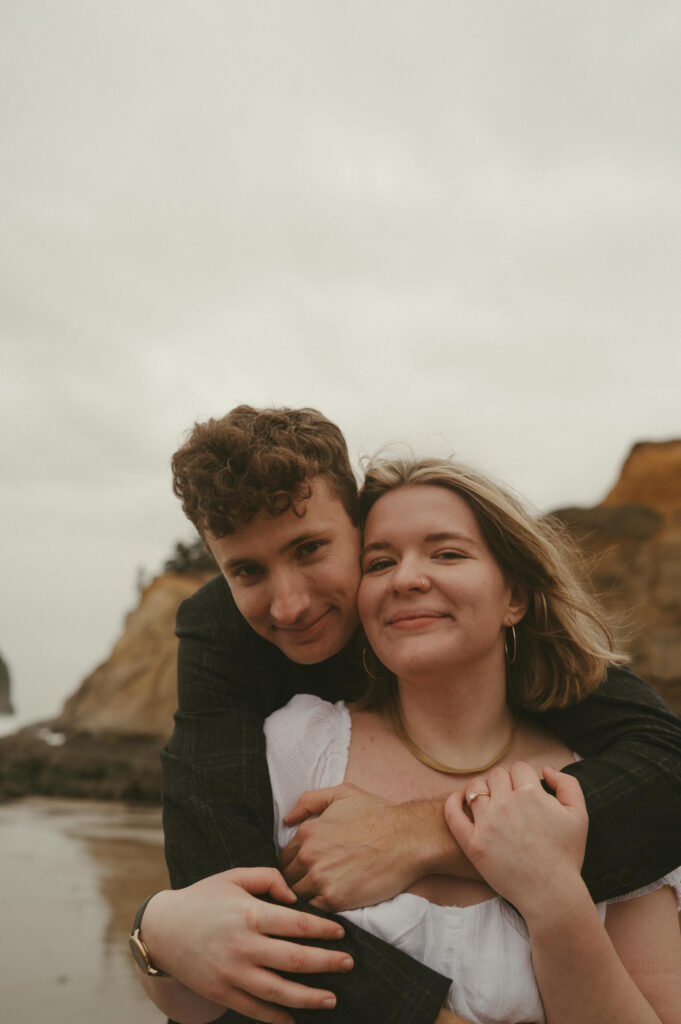 couple embracing during oregon coast engagement session