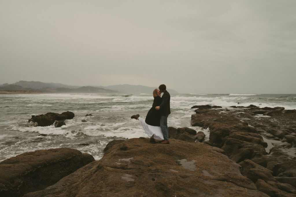 couple kissing during oregon coast engagement session