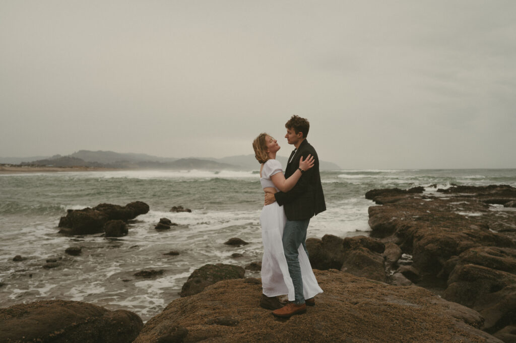 couple dancing on the rocks at cape kiwanda