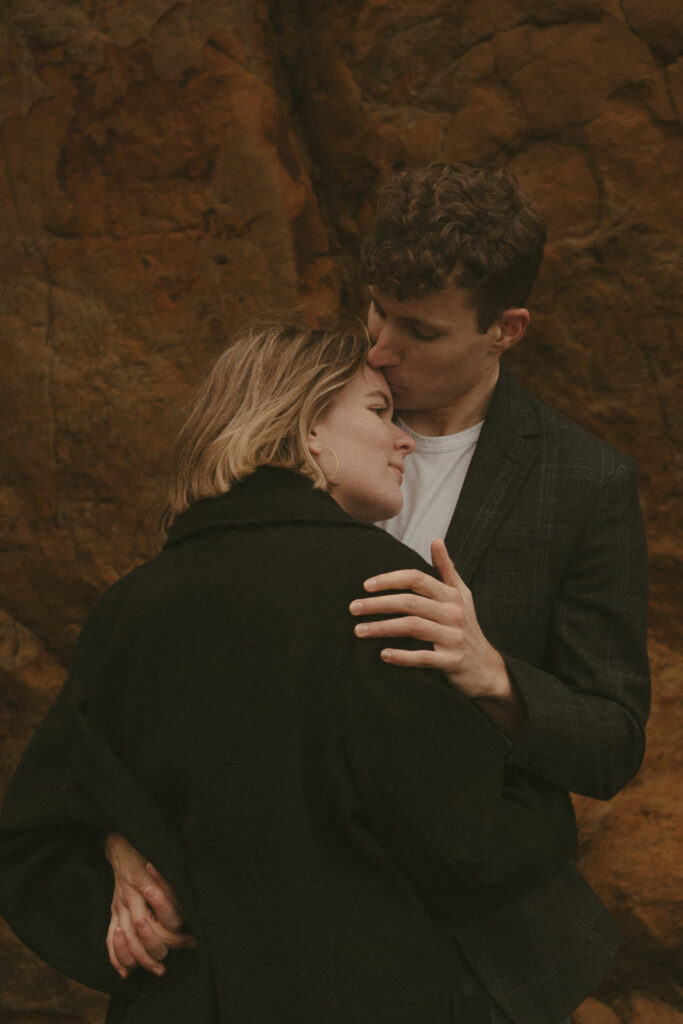 couple embracing at cape kiwanda