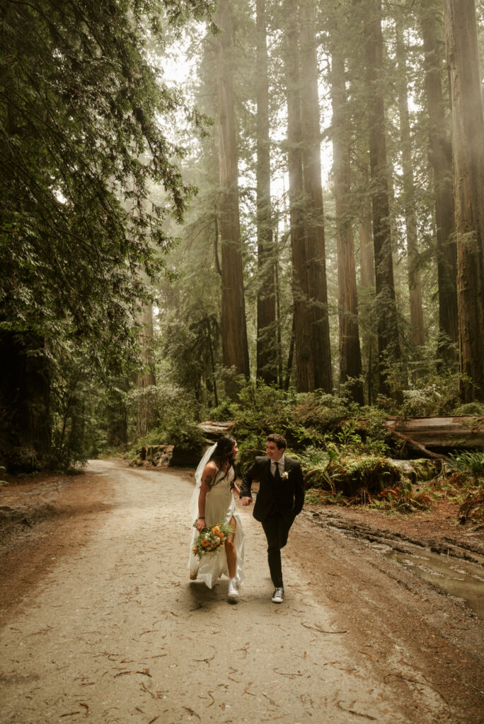 couple running during redwoods elopement
