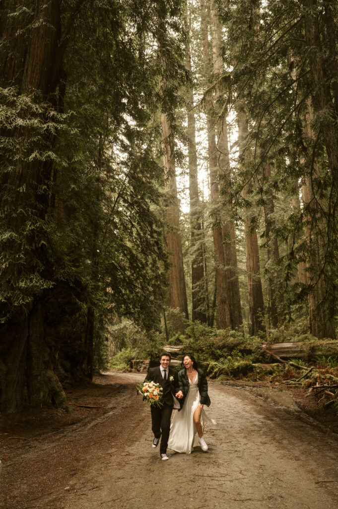 couple running in road redwoods elopement