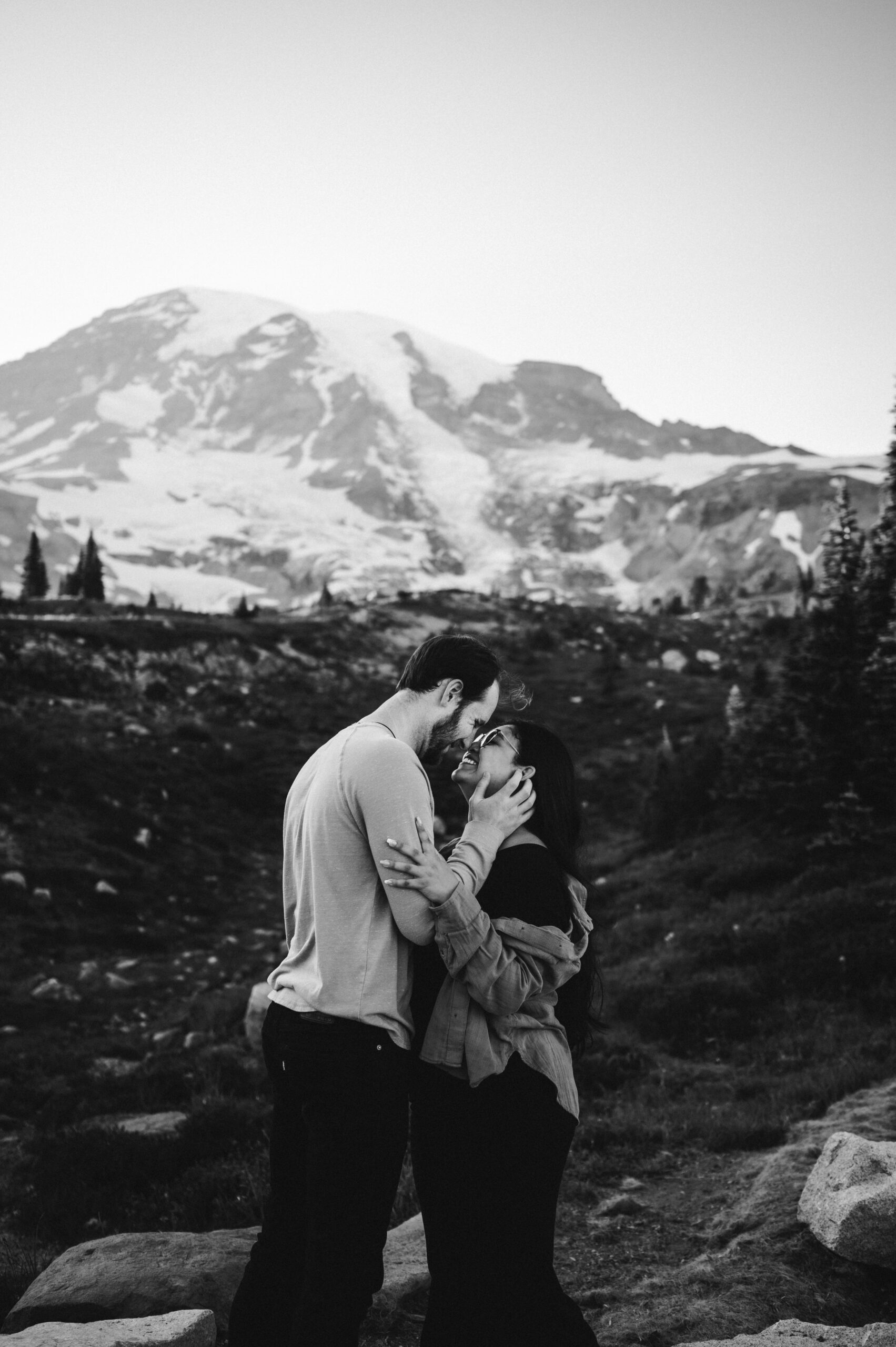 couple kissing under mountain