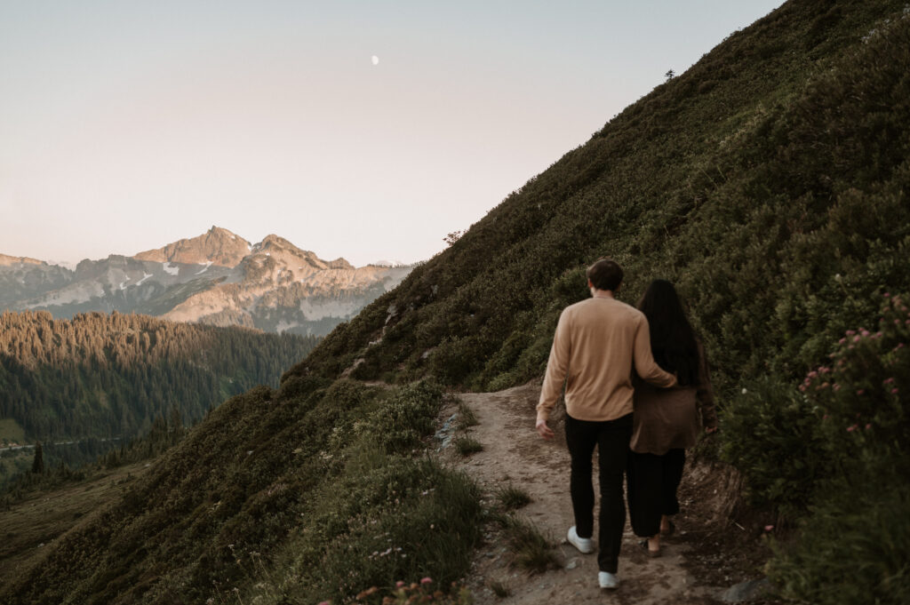 couple walking in front of Tatoosh Range in Washington; mountain engagement photos