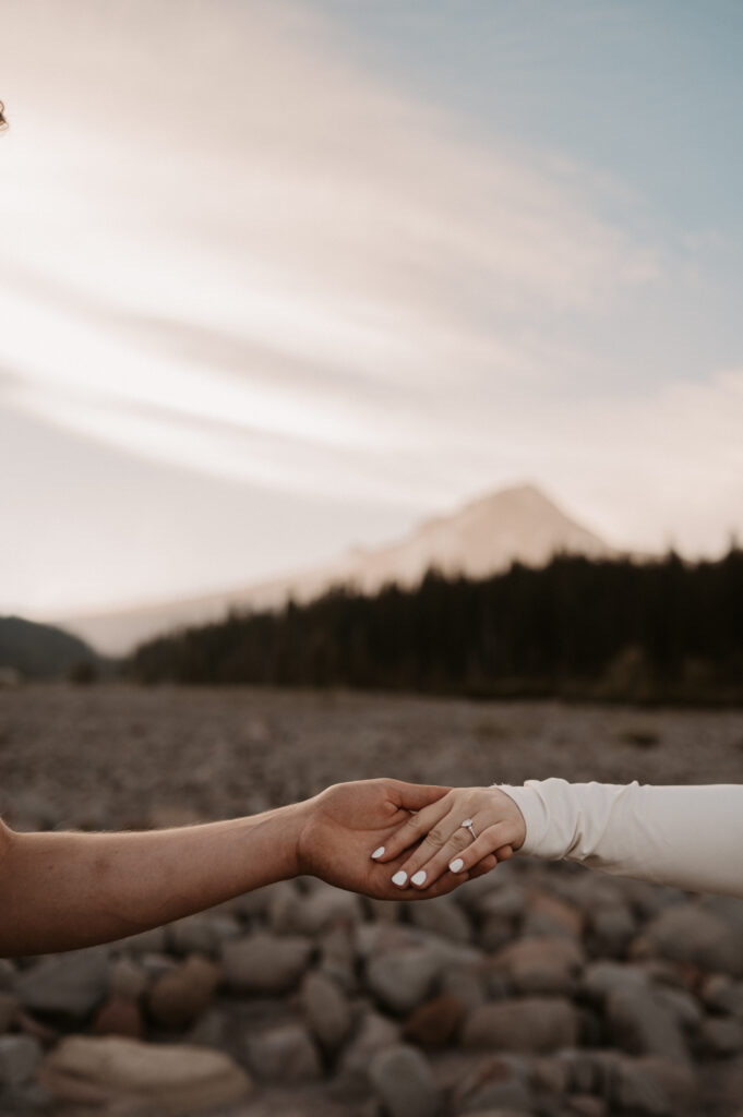 Engagement ring in front of Mount Hood