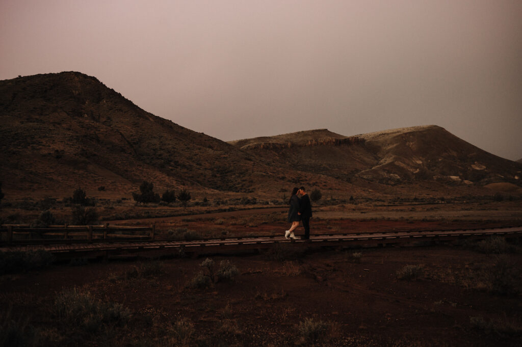 Couple kissing in thunderstorm at Painted Hills, Oregon